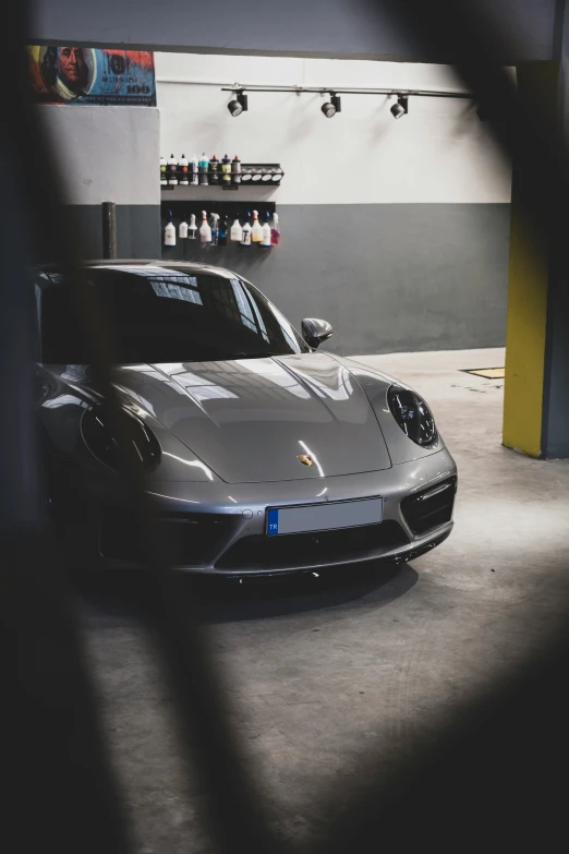 a gray car is parked in a garage