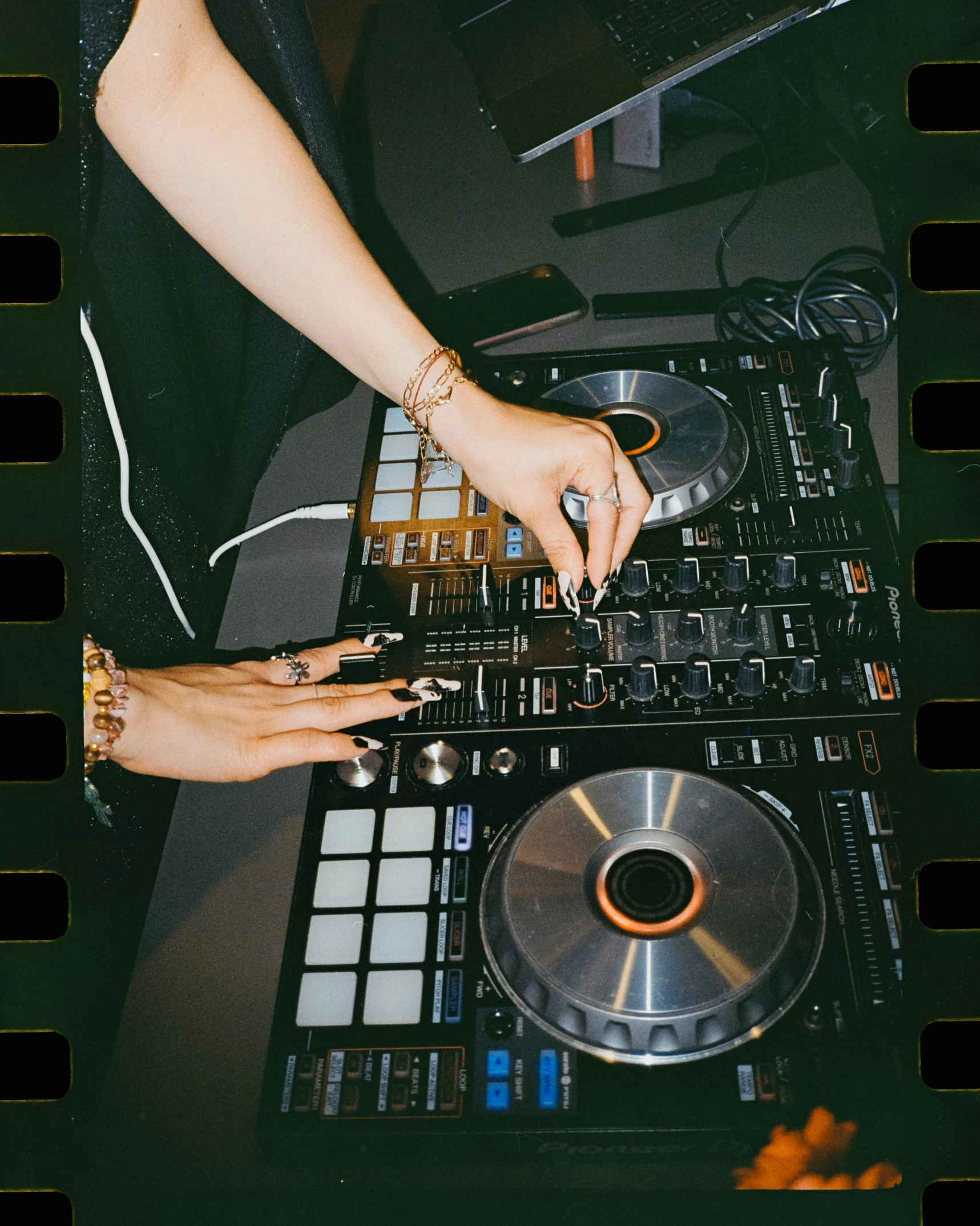 a close up of two people touching a dj turntable