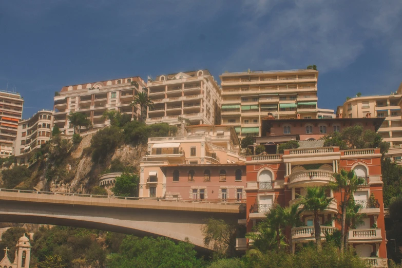 a bunch of buildings sit on top of a hillside