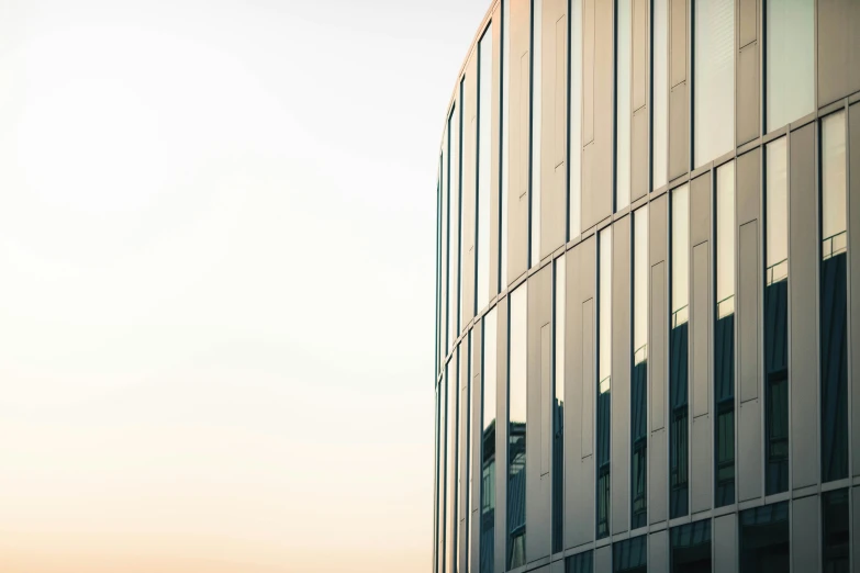 a large building with lots of windows is against a blue sky