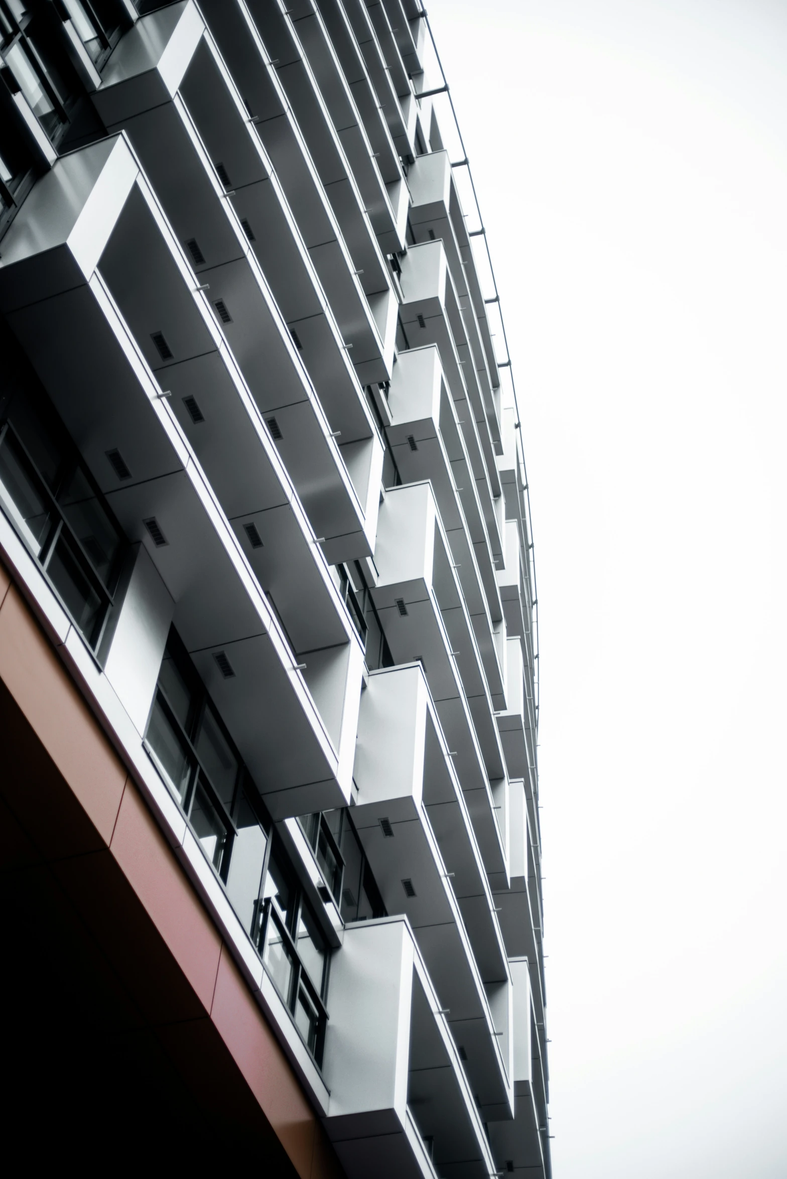 a high rise building with balconies against a blue sky