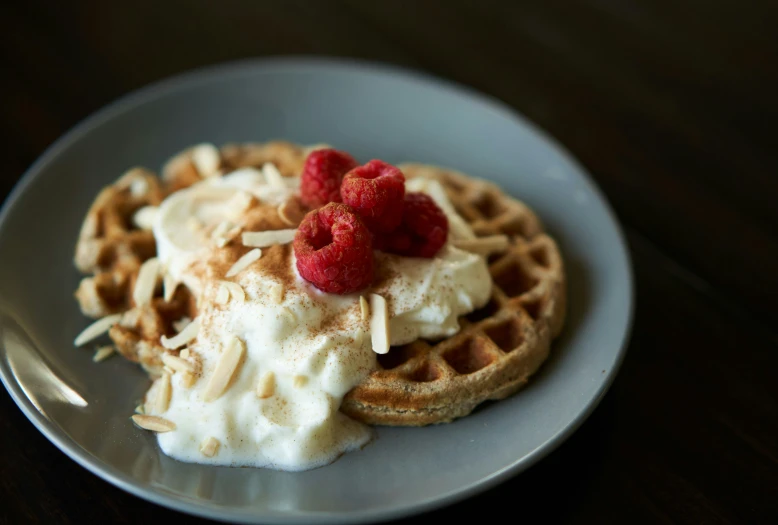 a plate with waffles topped with fruit and ice cream