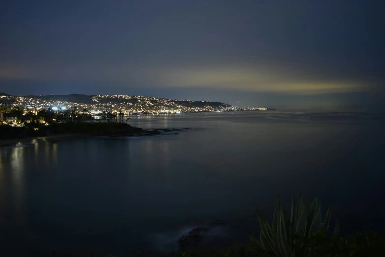 a city is on a hillside at night