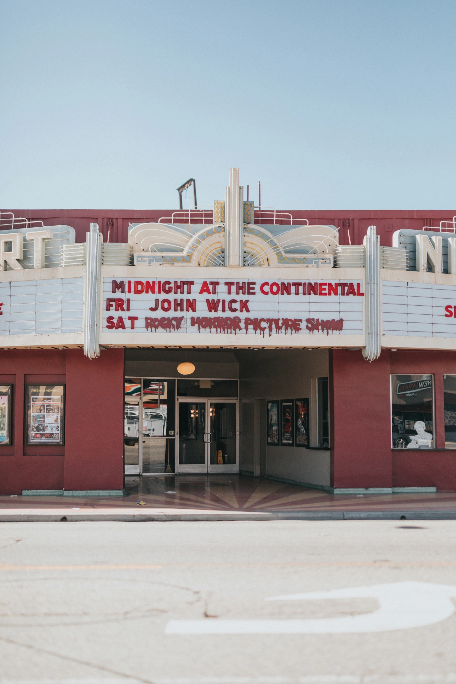 a large building with a movie screen on it