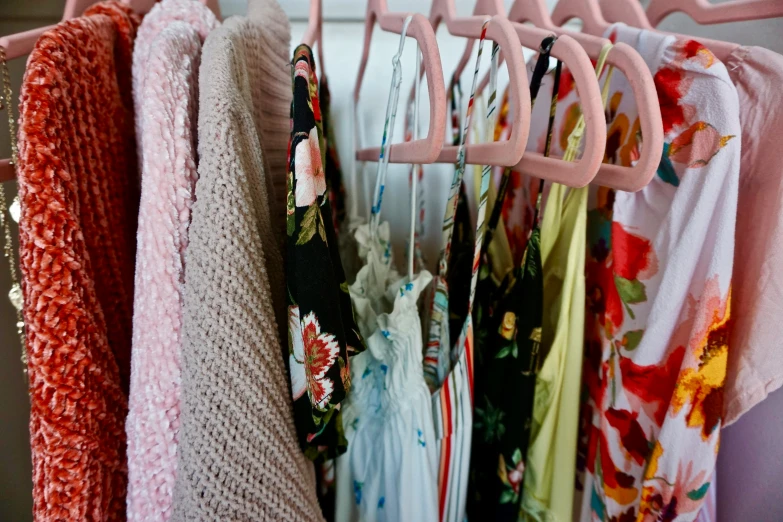 a clothes rack that has many different clothes hanging