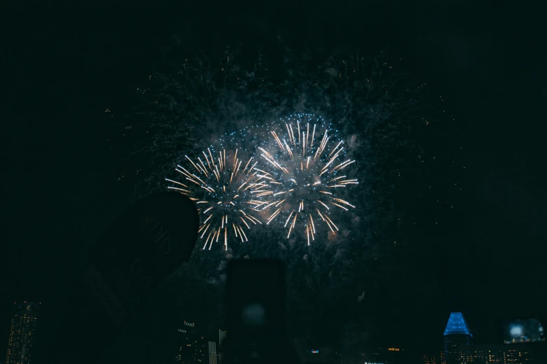 a large fireworks in the dark with very bright lights