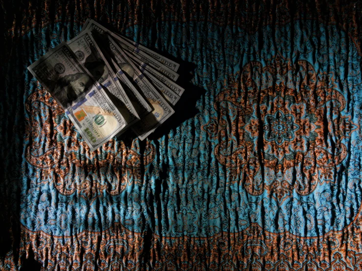 a bunch of money is laying on top of a rug