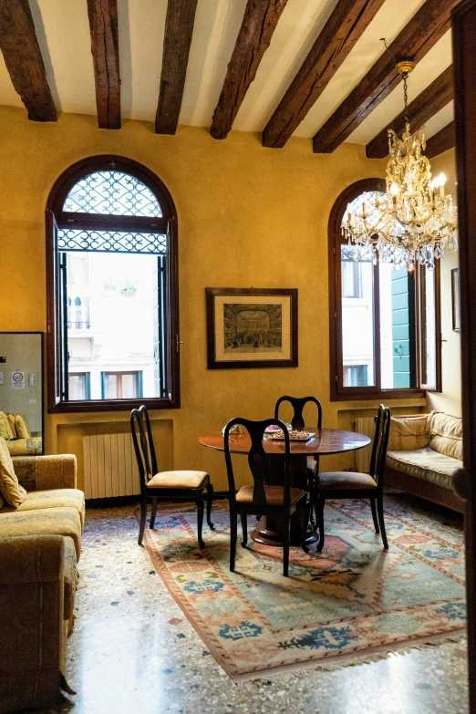 an old room with chairs, table and two couches