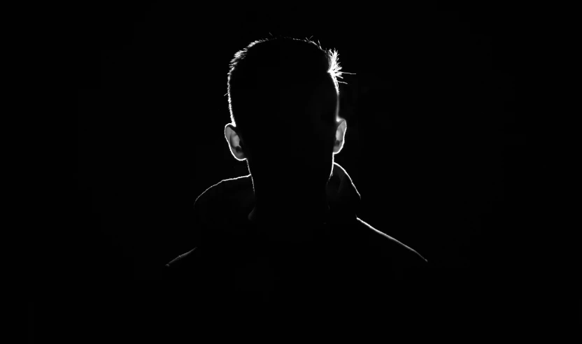 the silhouette of a man in the dark