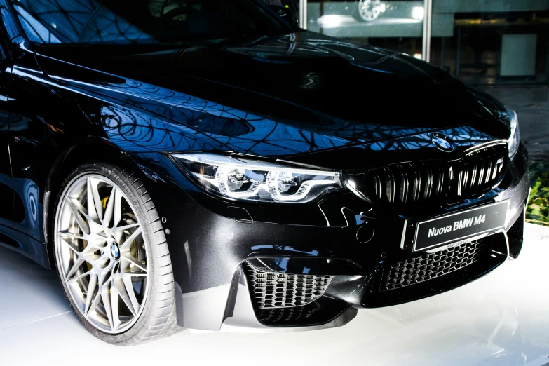 a black bmw in front of a building