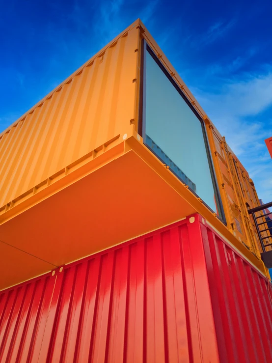 the side of a large yellow container with a window on it