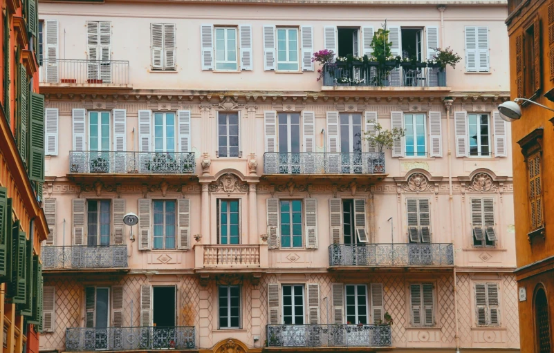 a building with some balconies on it next to a street