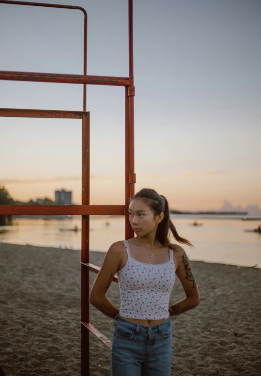 a woman with her arms crossed on a beach