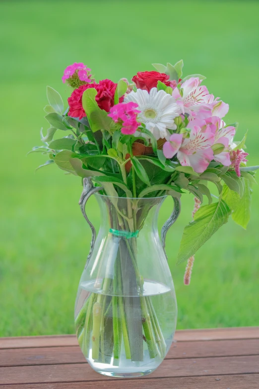 a glass vase filled with pink and white flowers