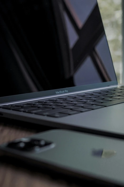 a close up of two laptops on a wooden table