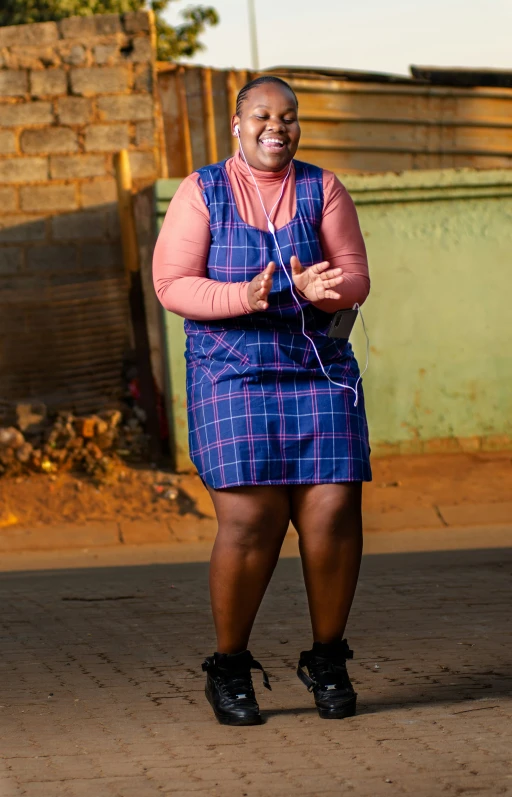 a woman with glasses in a blue dress is dancing