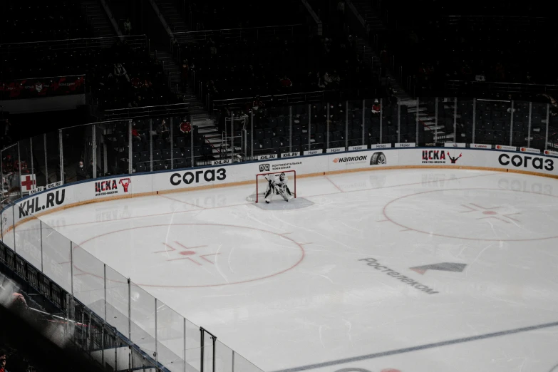 an ice hockey rink with two players playing on the rink