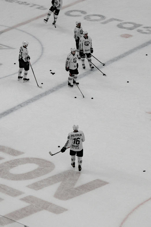 some hockey players are playing on the ice