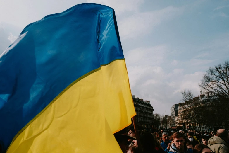 a blue and yellow flag flying in the air