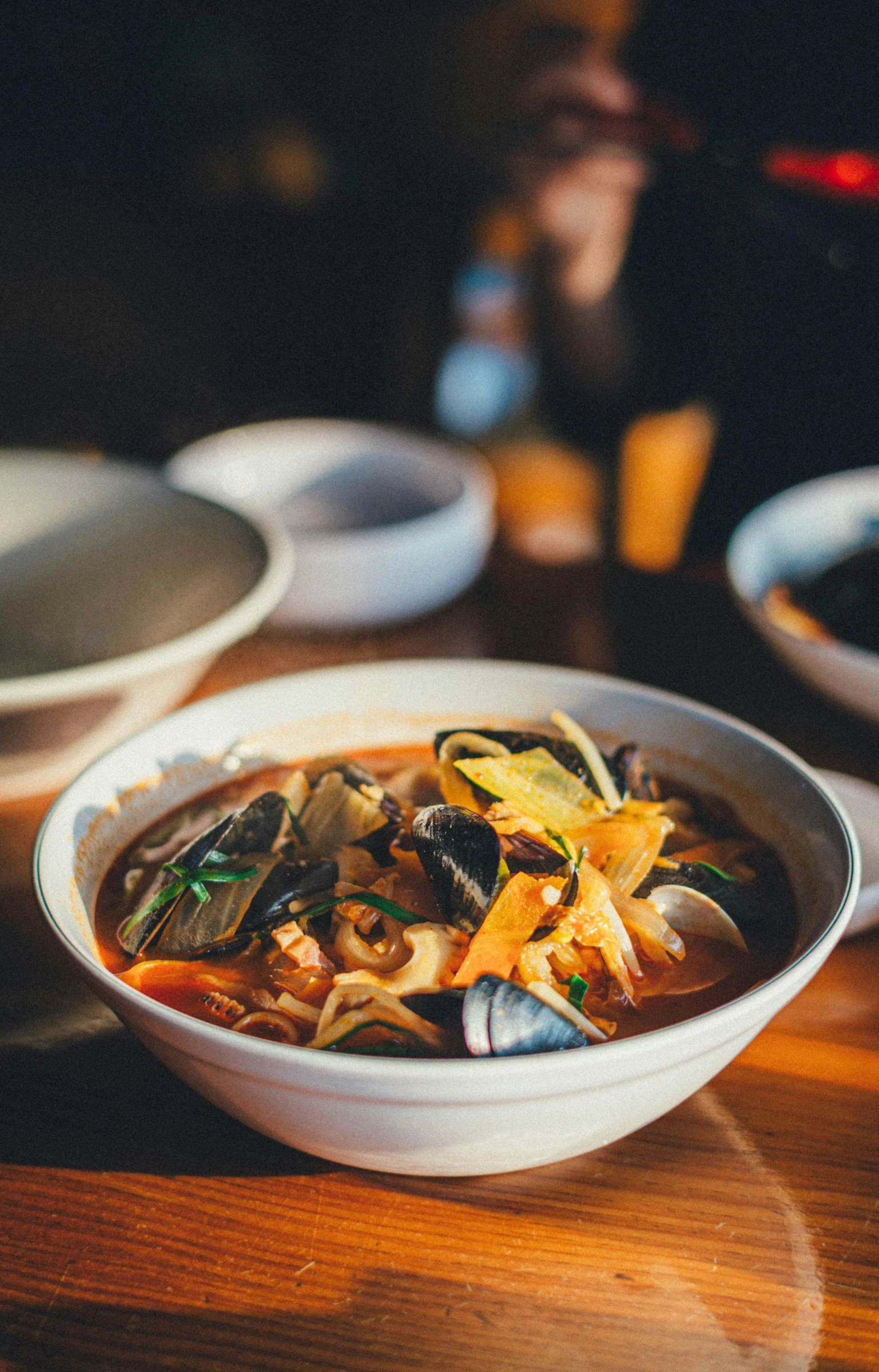 a bowl with a variety of vegetables and noodles