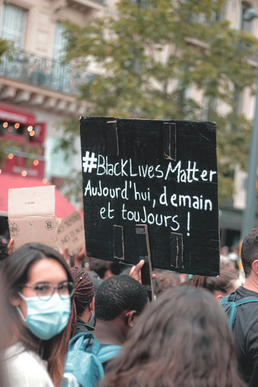 a protest with several people wearing protective masks