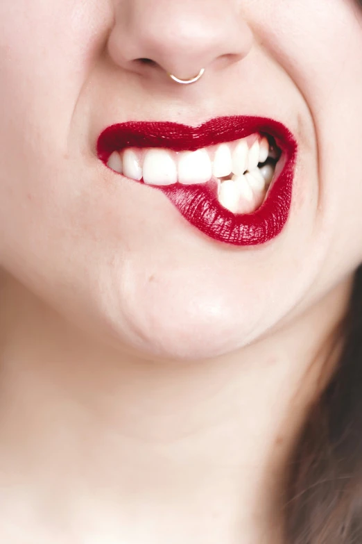 a woman has a fake red lips on her lip