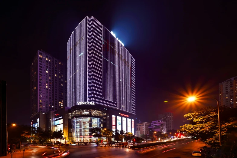 a night time view of the city with cars moving around