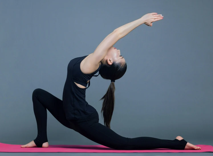 a woman doing yoga stretches on a pink mat