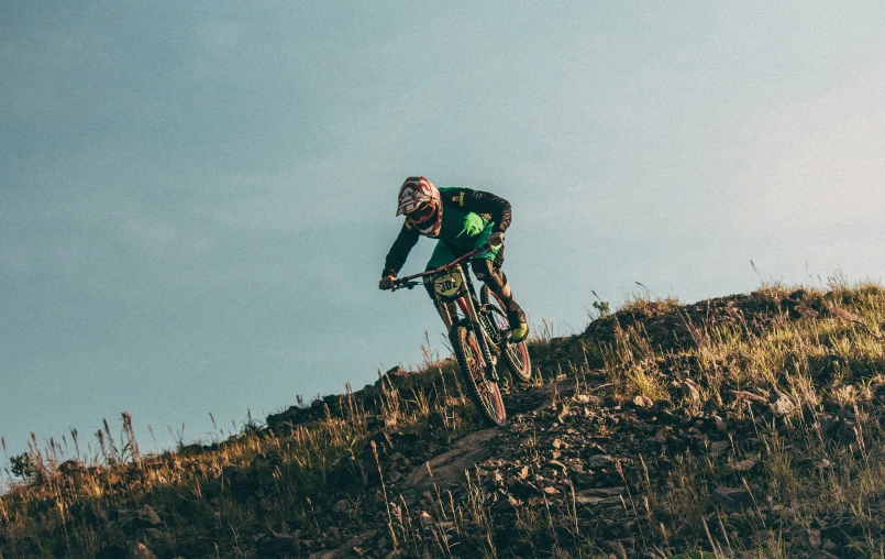 a person on a bike riding down a hill