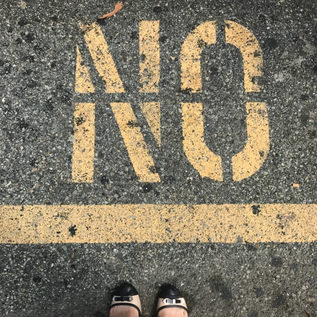 a pair of shoes are shown in front of the yellow line