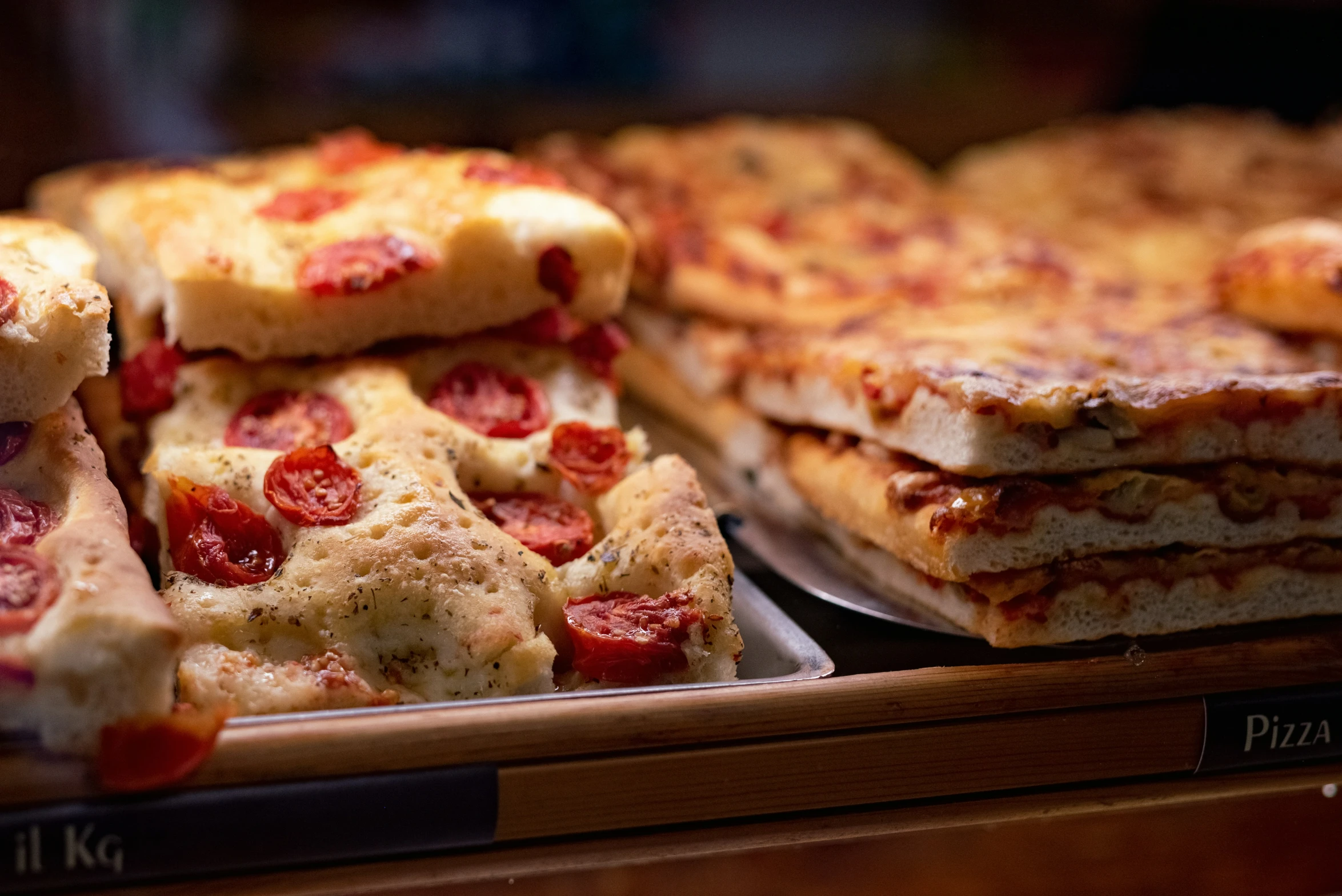 pizza slices arranged on display in the case