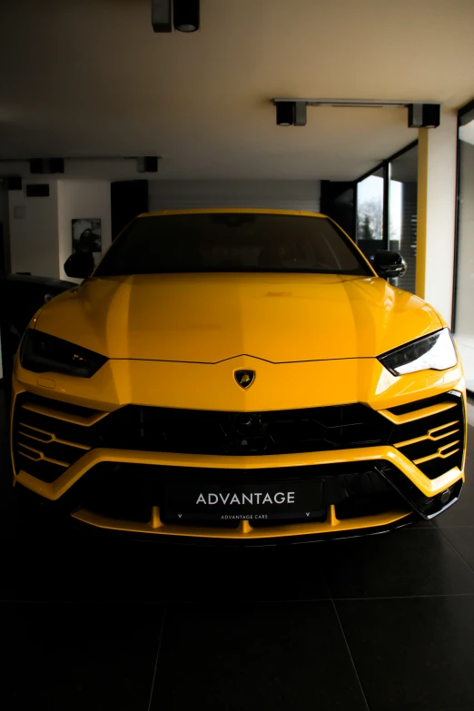 yellow lamb - type car is shown in a large room