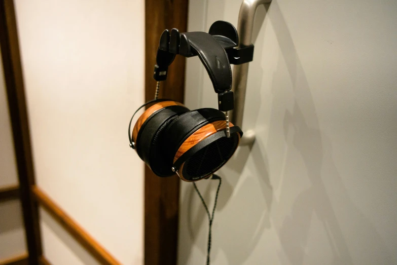 headphones hanging on the wall next to a door