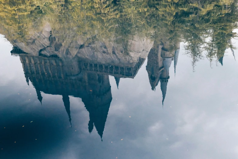 an old building reflected in the water of a lake