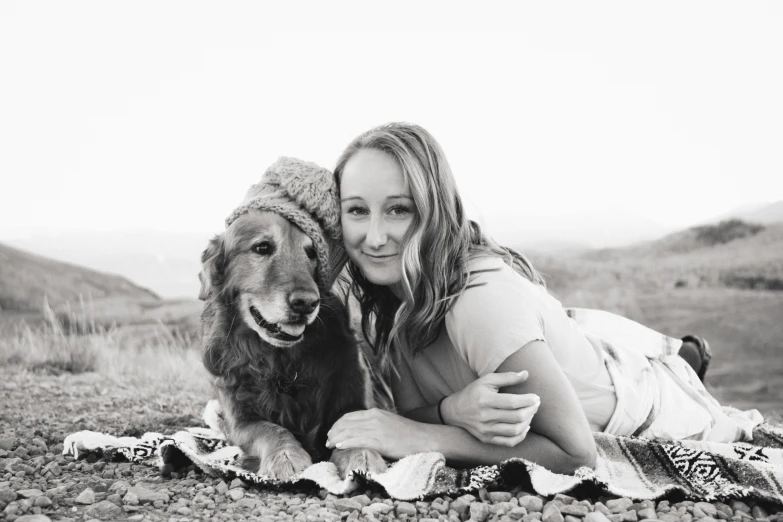 a girl hugging a dog on the ground