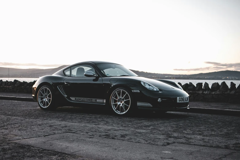 a black sports car driving down the road