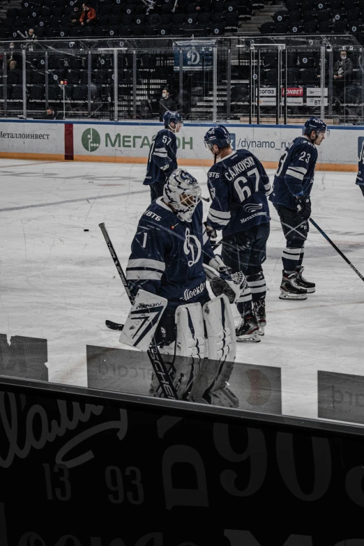 group of ice hockey players congratulating on the bench