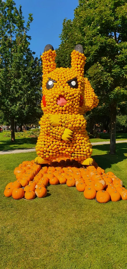 the giant pumpkin sculpture is made of plastic bottles