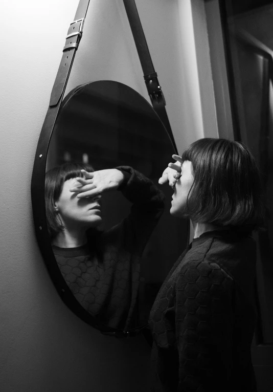 a woman is putting her makeup in the mirror