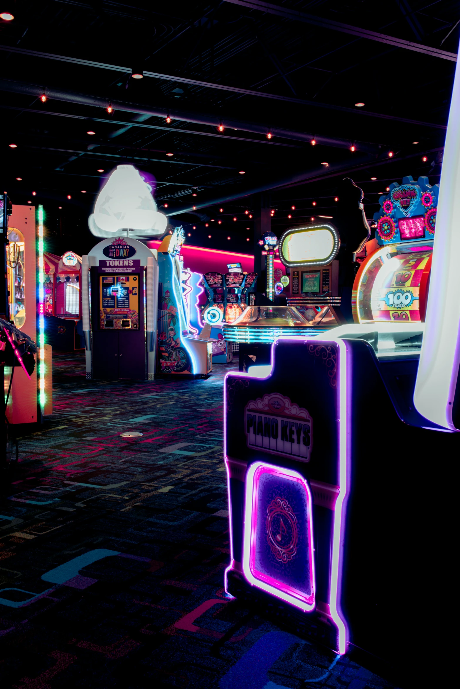 the arcade machines are lit up with neon lights