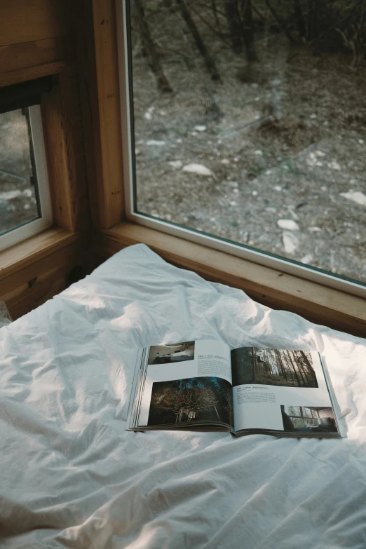 two books on a bed in a room