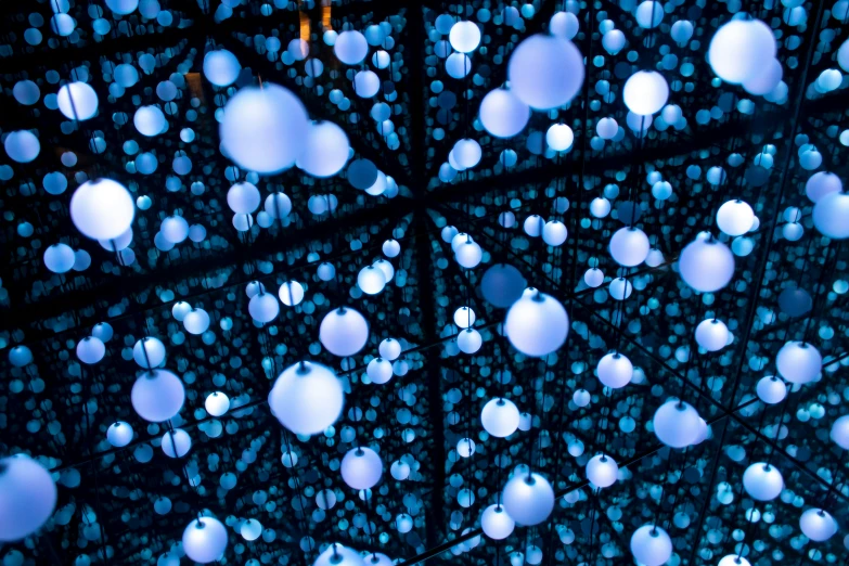 a decorative array of large, multi - colored ball floats against a blue background