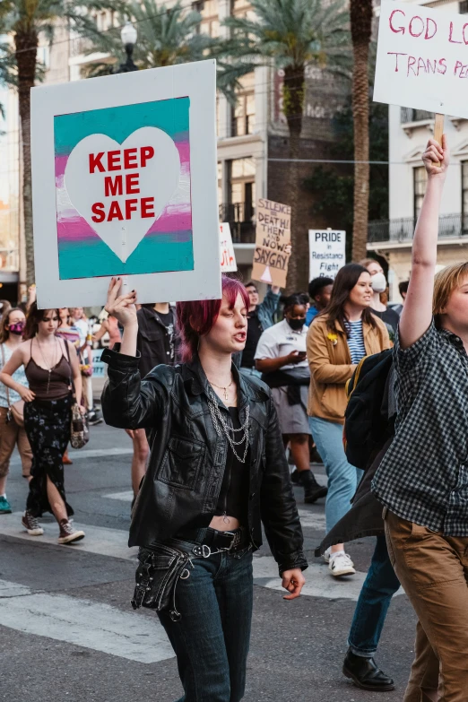 a man and woman holding a sign while marching