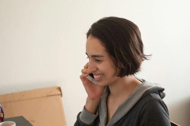 an asian girl talking on her cell phone and smiling