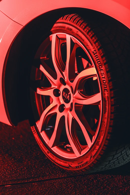 close up view of a rim on a red colored sports car