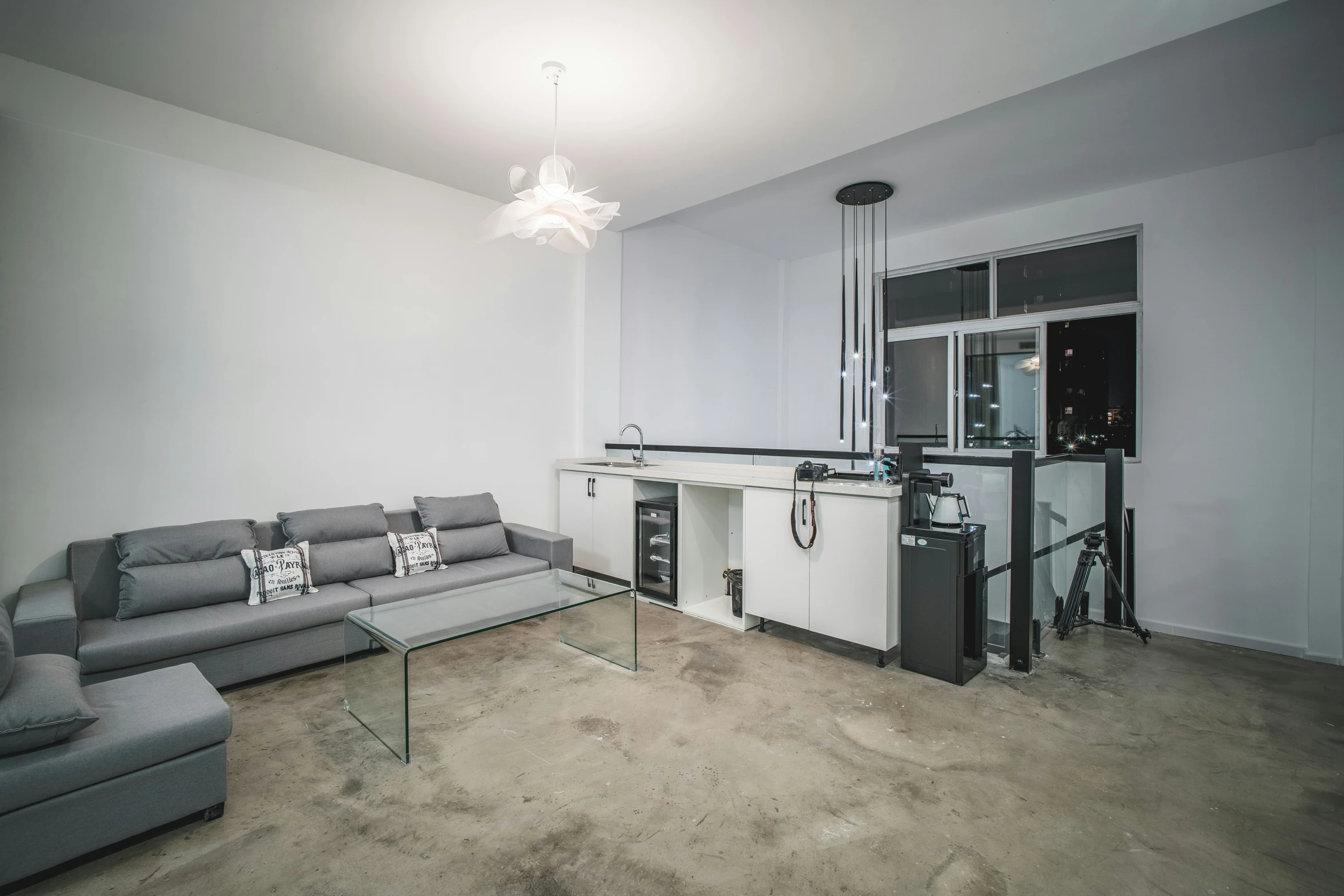 a living room with a sectional and a chandelier