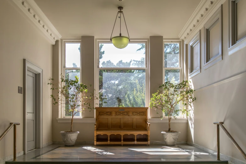 an empty building with benches next to windows