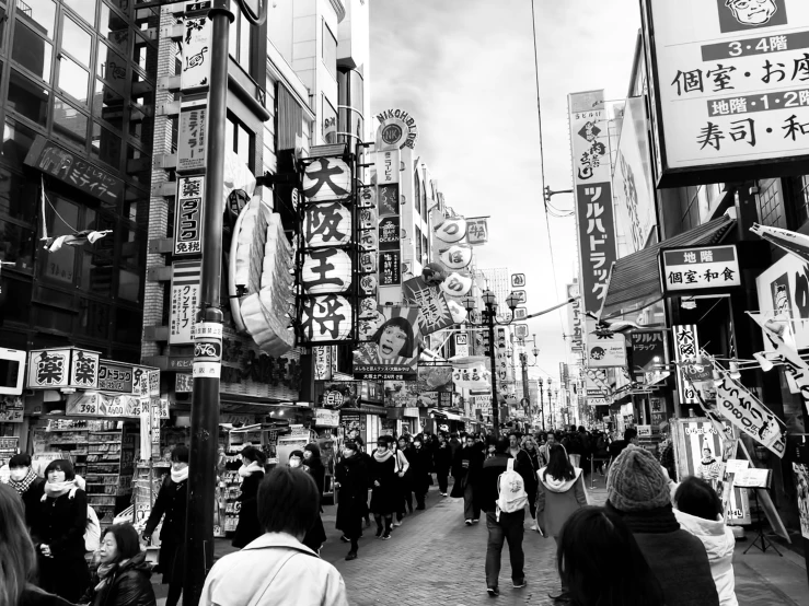 a black and white po of a crowded asian street