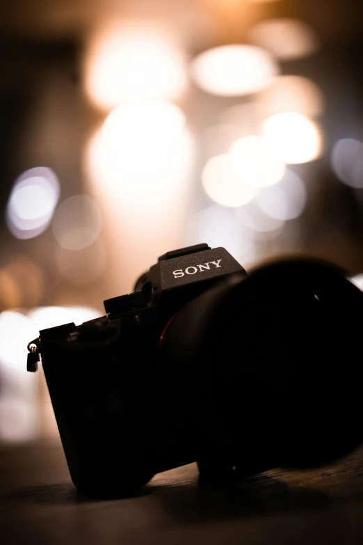 a sony camera is on a table in front of some lights