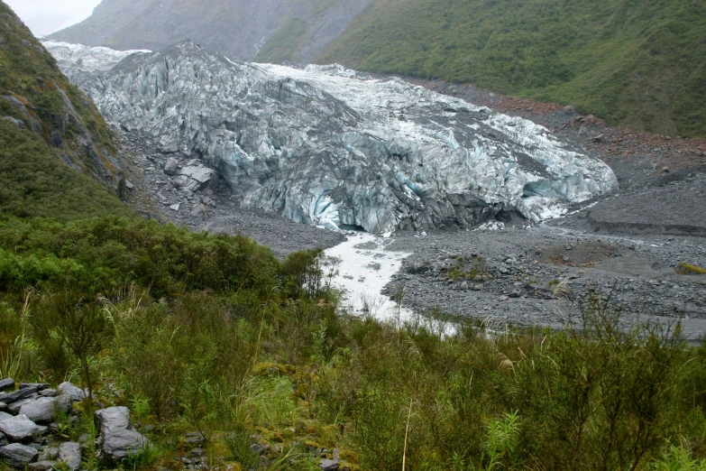 a large glacier with very large chunks of snow on the side of it